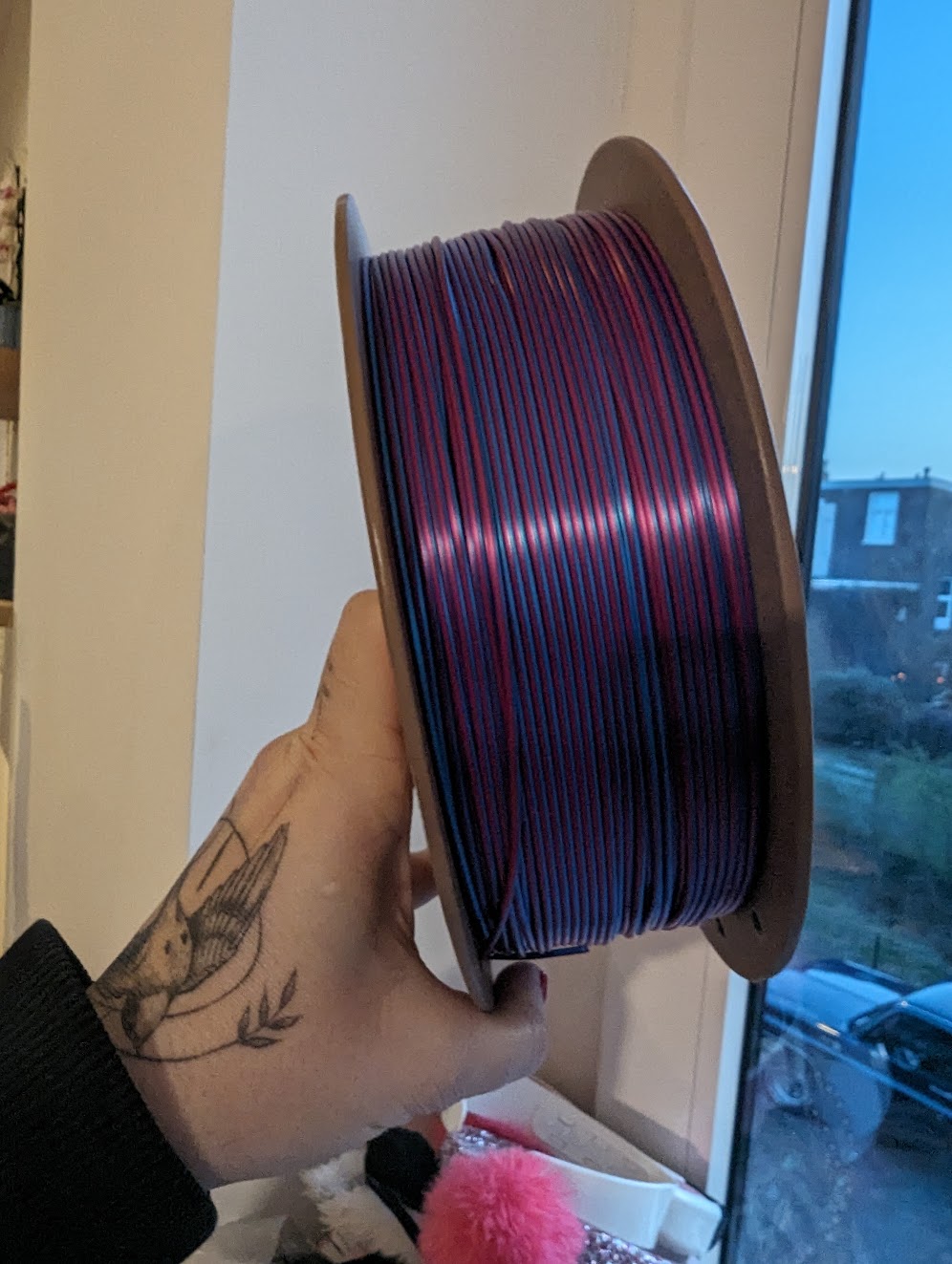 Picture showing a roll of 3D printing filament with 2 colors